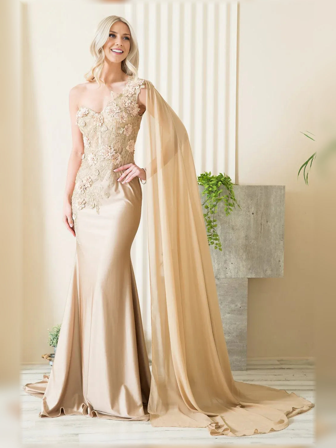 One-shoulder mermaid formal dress in champagne with floral lace bodice and flowing drape.