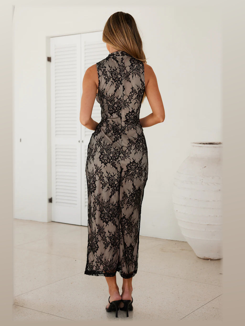 Black midi formal dress, back full-length view showing the bodice