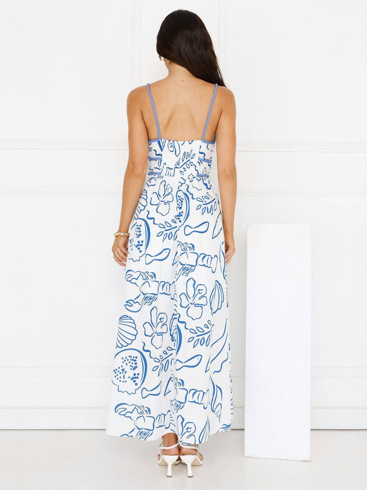 White a-line maxi formal dress with floral print, full-length back view