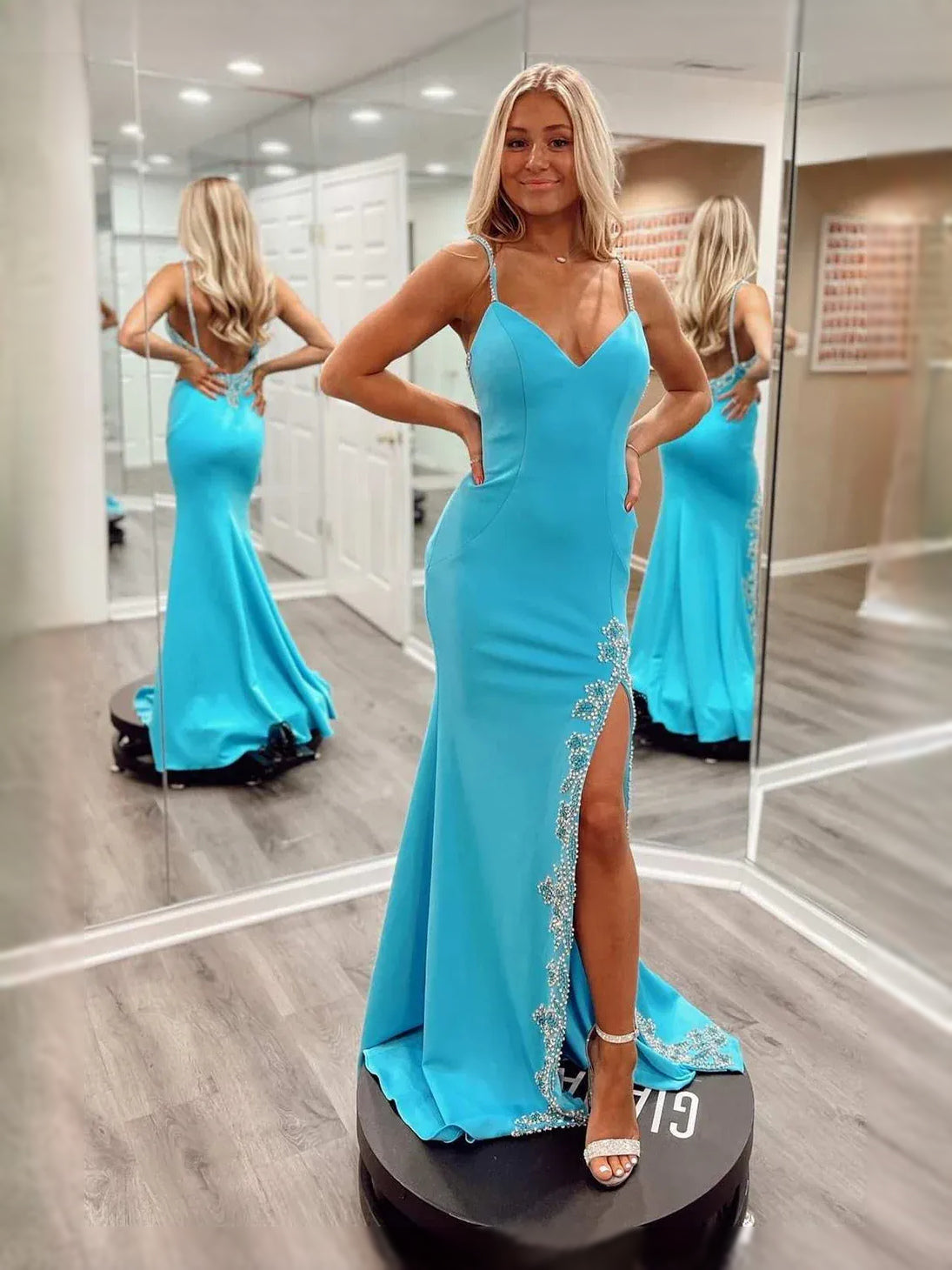 Turquoise satin mermaid prom dress with V-neck, thigh slit, and rhinestone straps