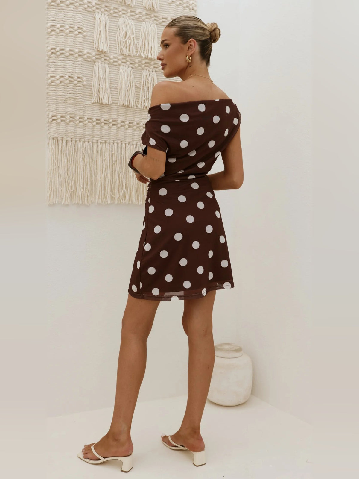 Brown polka dot mini off-shoulder dress, back view with short gathered sleeves.