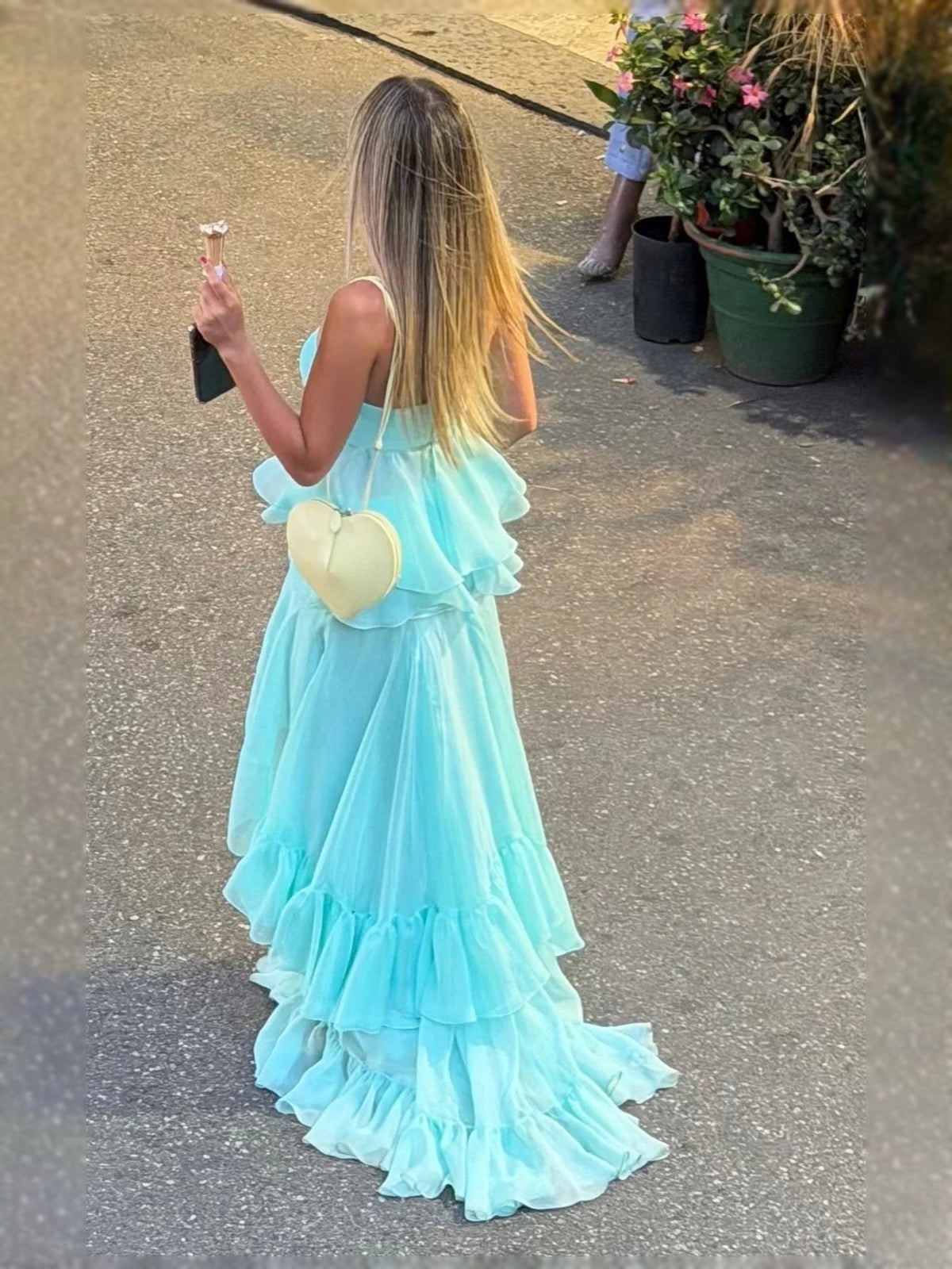 Aqua prom dress with tiered ruffle layers, viewed from back with thin straps