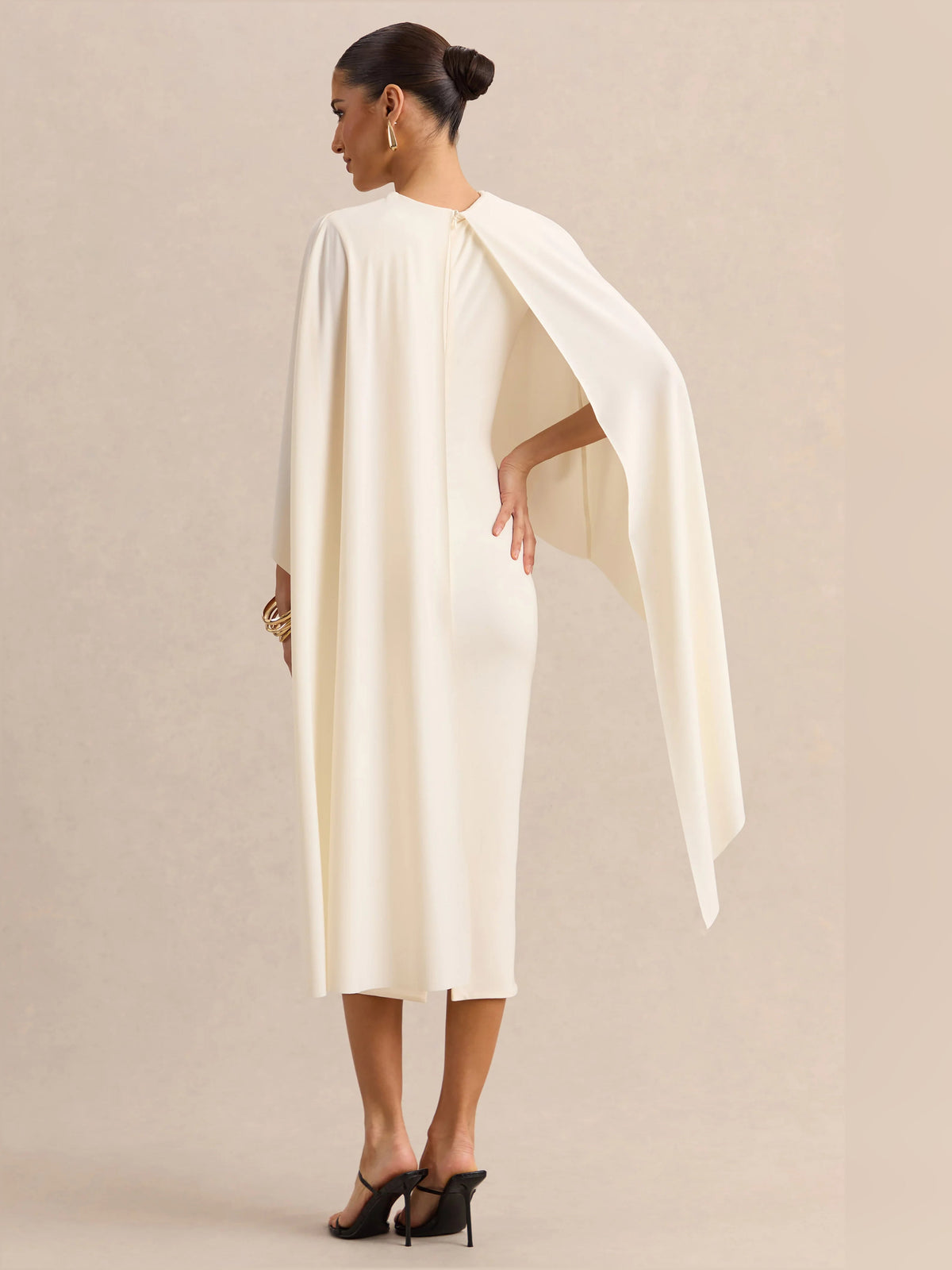 Cream midi formal dress back view with round neck and flowing cape-like sleeve drape