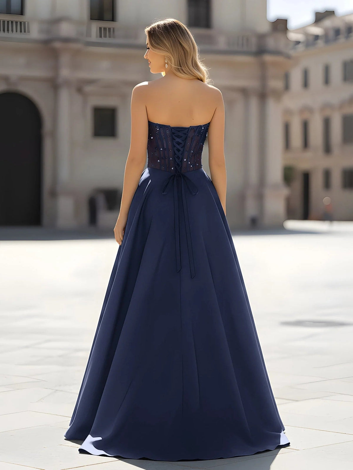 Dark navy corset back A-line prom dress with bow detail and floor-length skirt