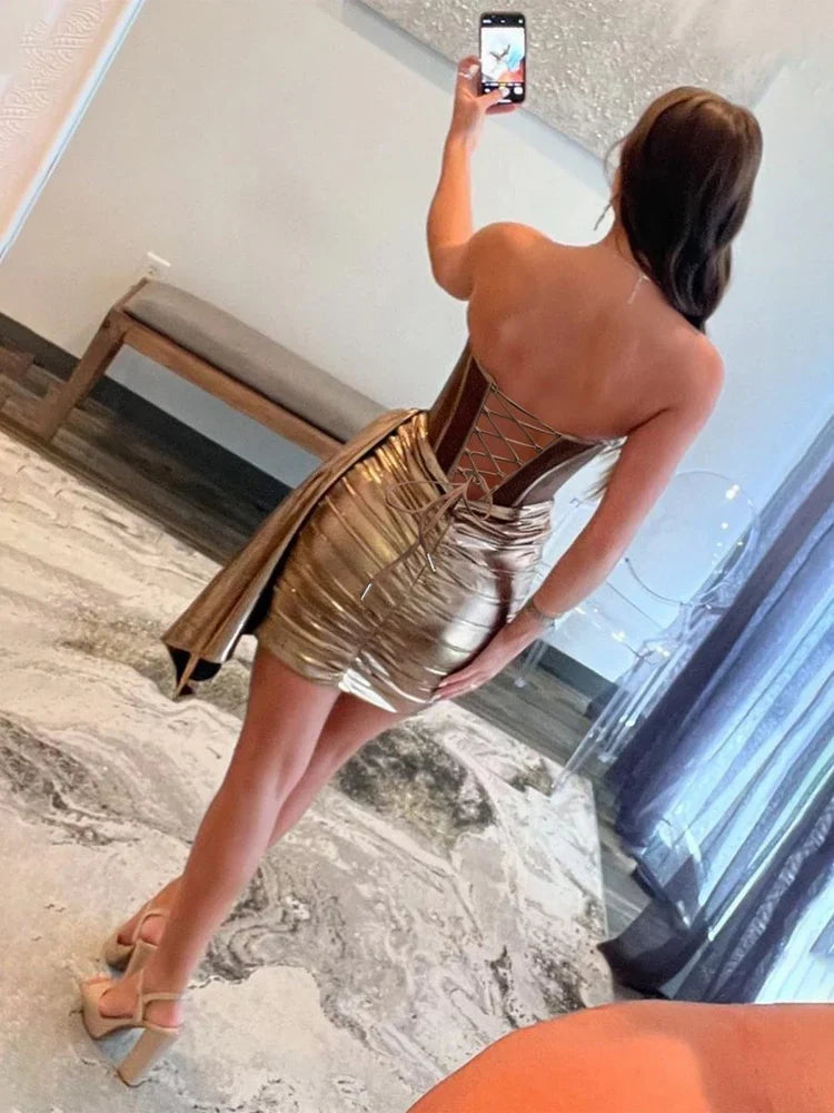 Back view of metallic gold mini dress with ruched draped sheen and corset-style boning