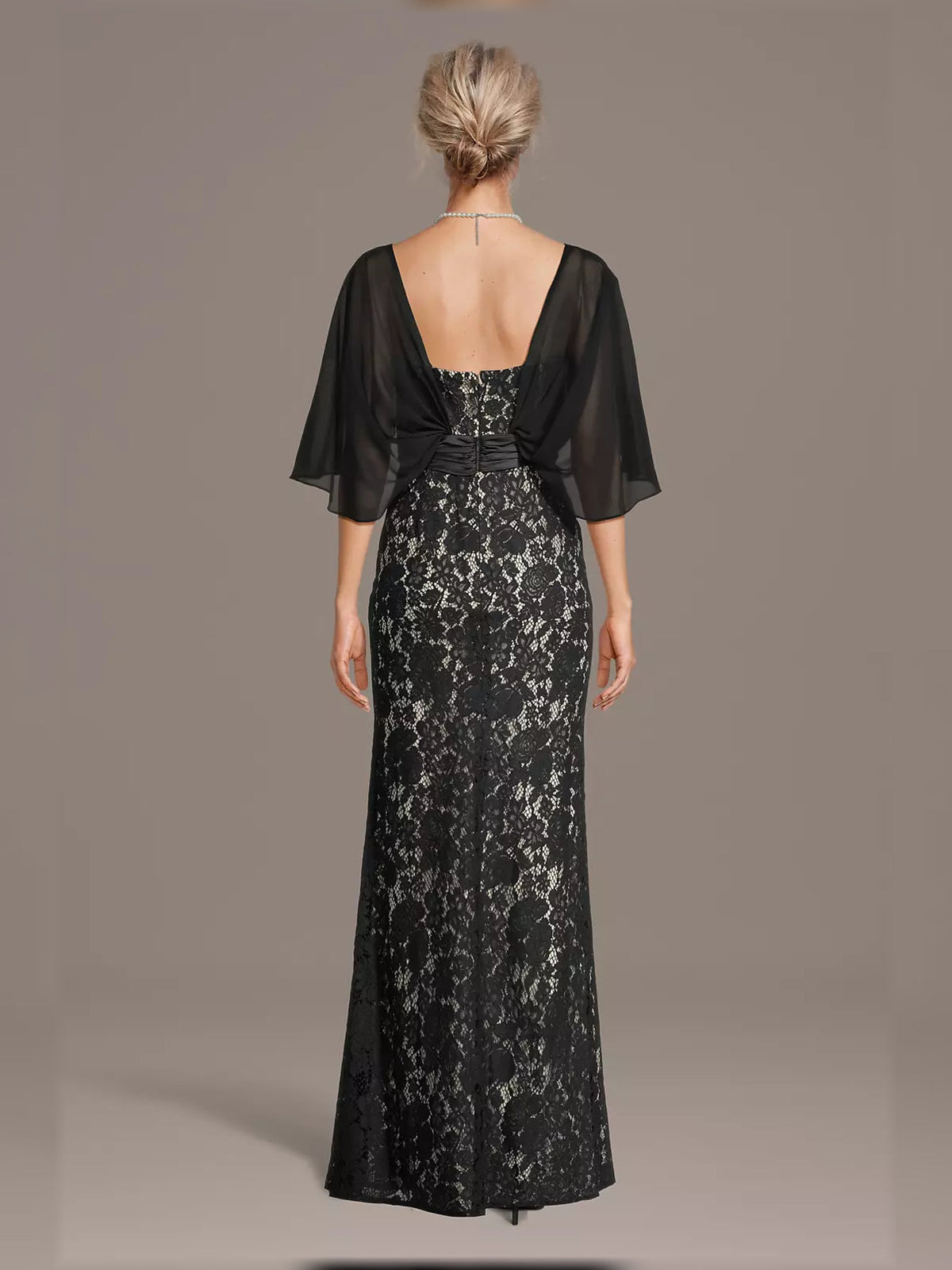 Back view of black lace mermaid maxi dress with sheer sleeves and satin ruched waist