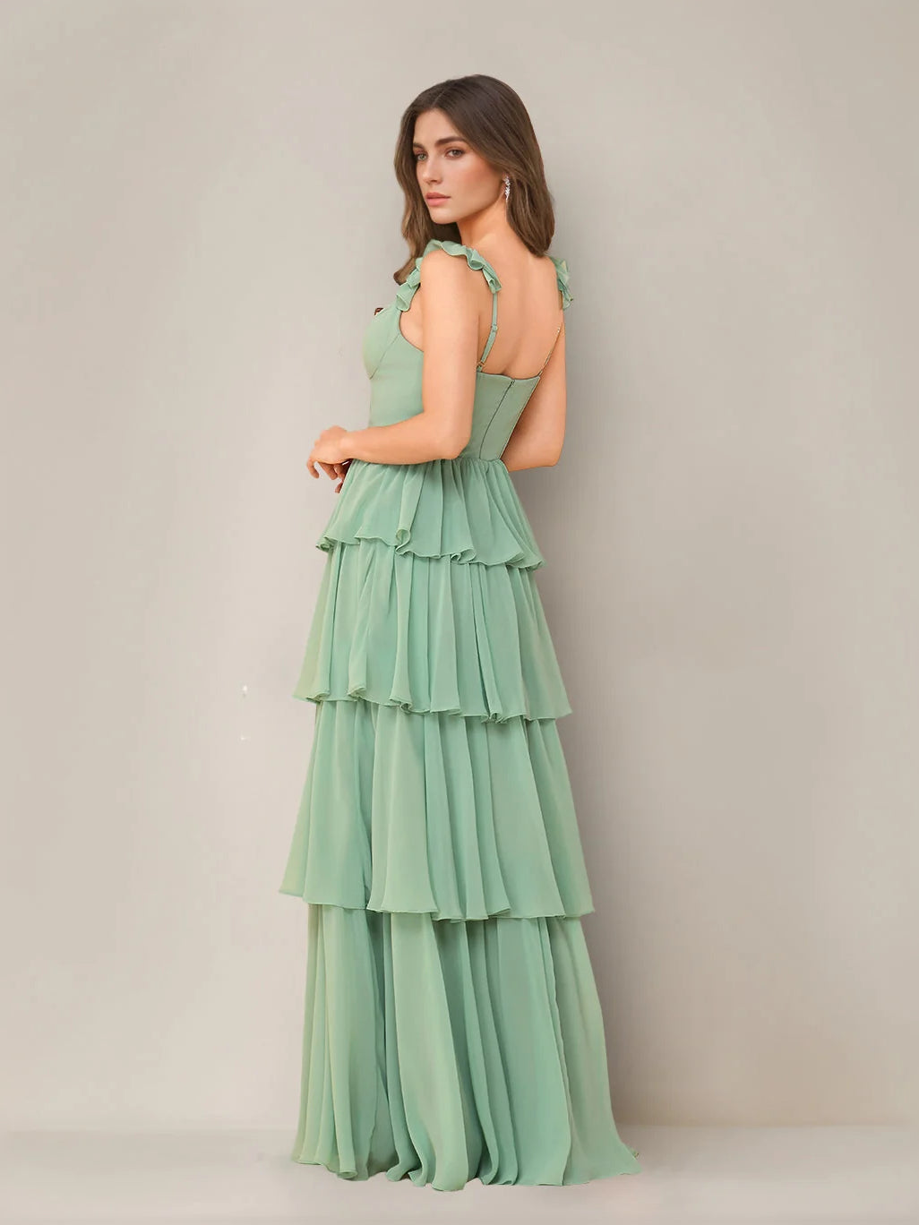 Mint green tiered ruffled sleeveless maxi dress shown from the side, with side slit