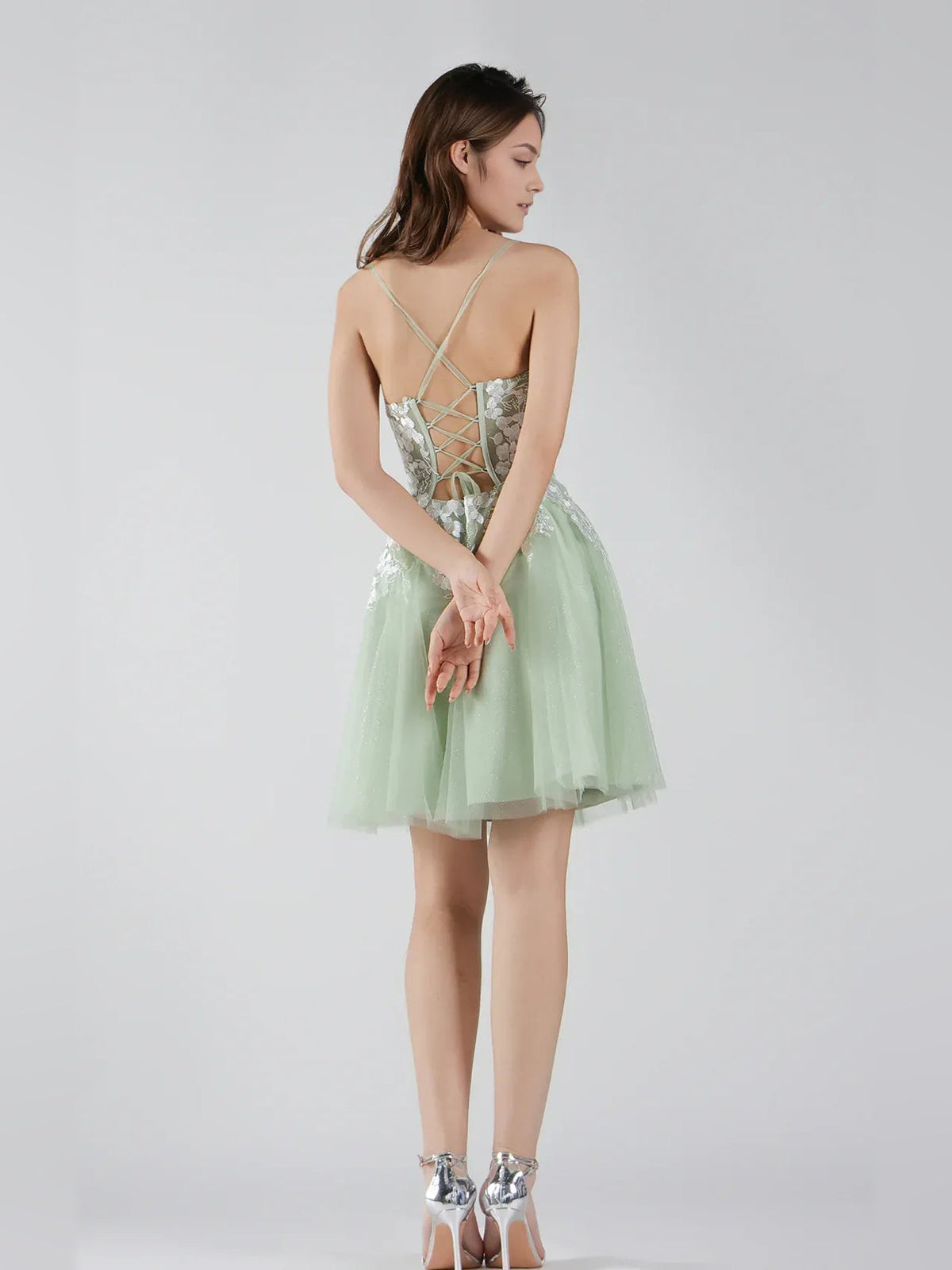 Sage green tulle mini dress with lace-up corset back and thin crisscross straps