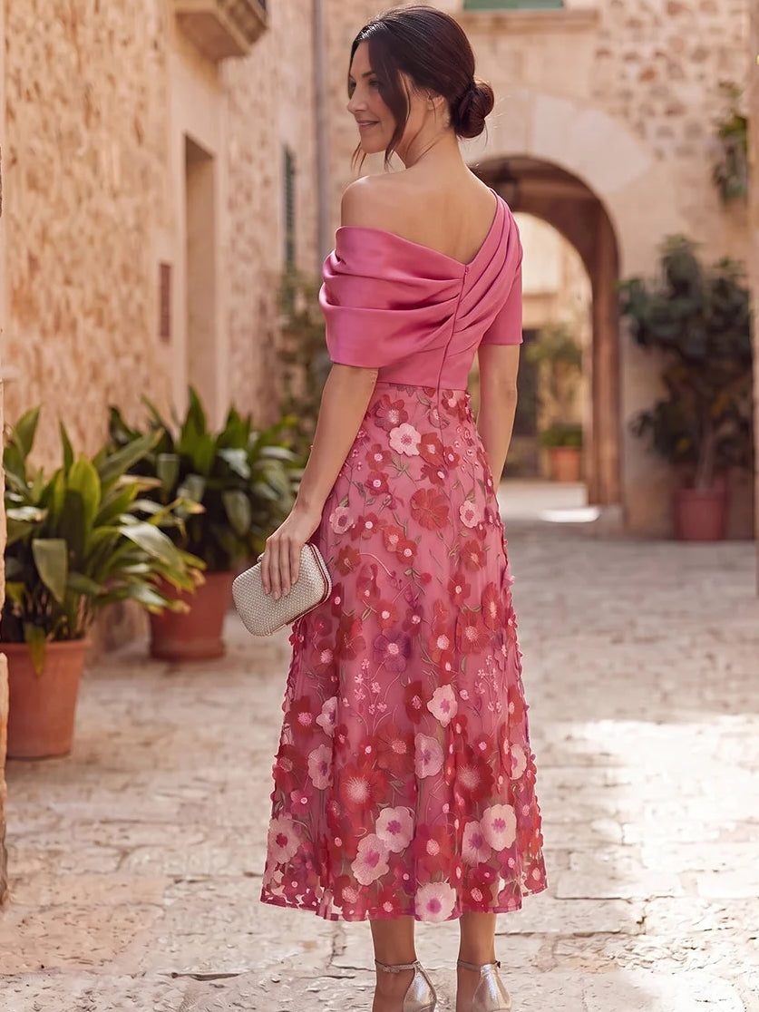 Hot pink one-shoulder draped satin midi dress with floral A-line skirt, side view
