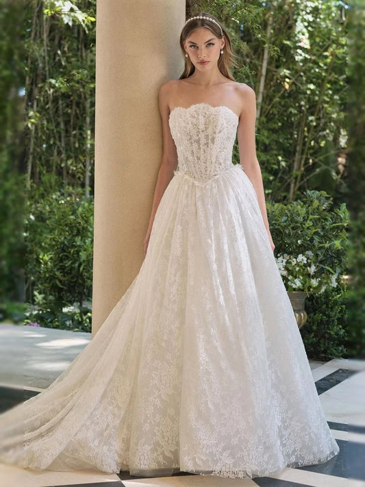 Ivory strapless sweetheart corset wedding dress with lace bodice and full tulle skirt