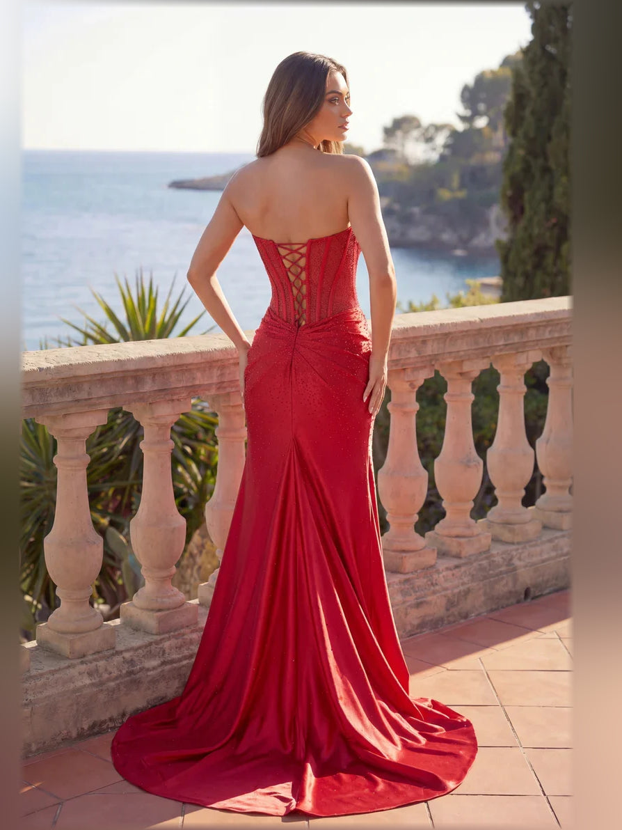 Red corset formal dress back view with off-shoulder neckline and draped floor skirt