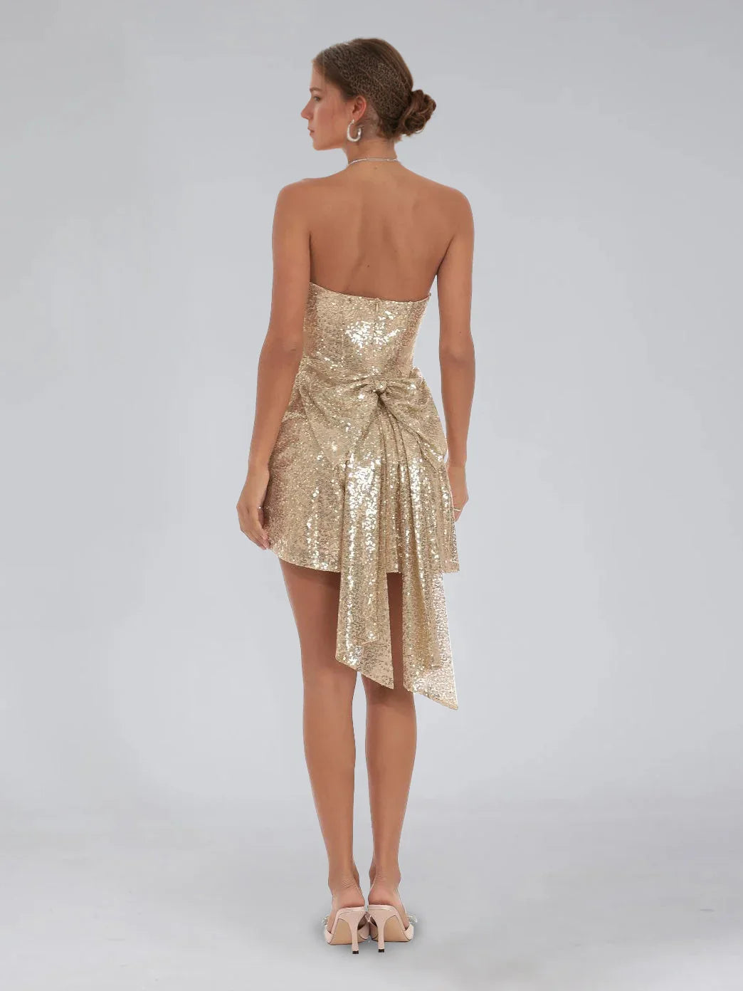 Champagne gold sequin strapless mini A-line dress, back view with bow sash