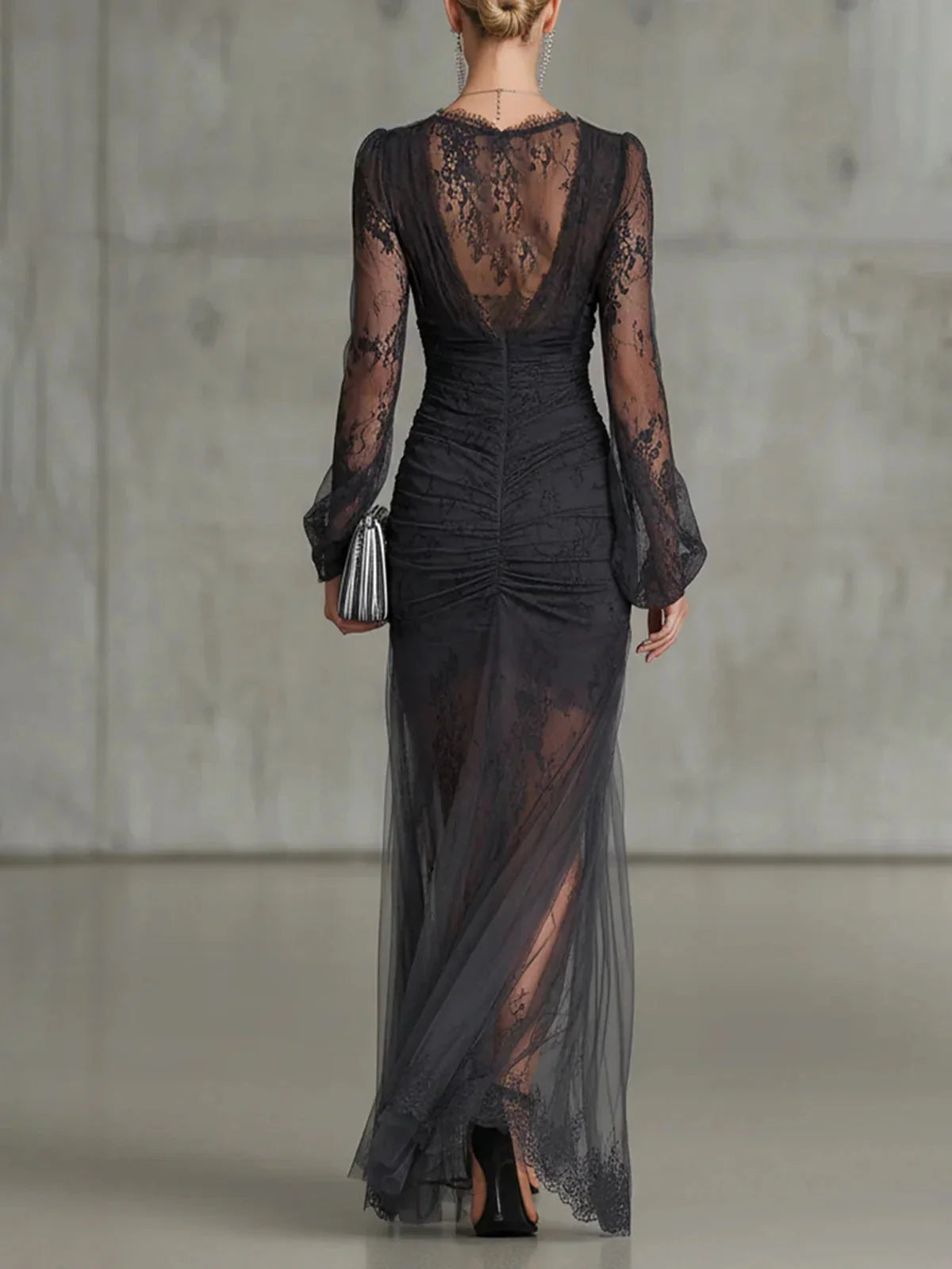 Black floral lace formal gown with low back, long sleeves, ruched waist and slit