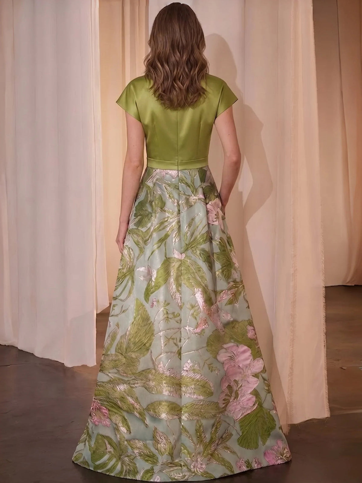 Back view: green V-neck A-line satin dress with floral full skirt and short sleeves