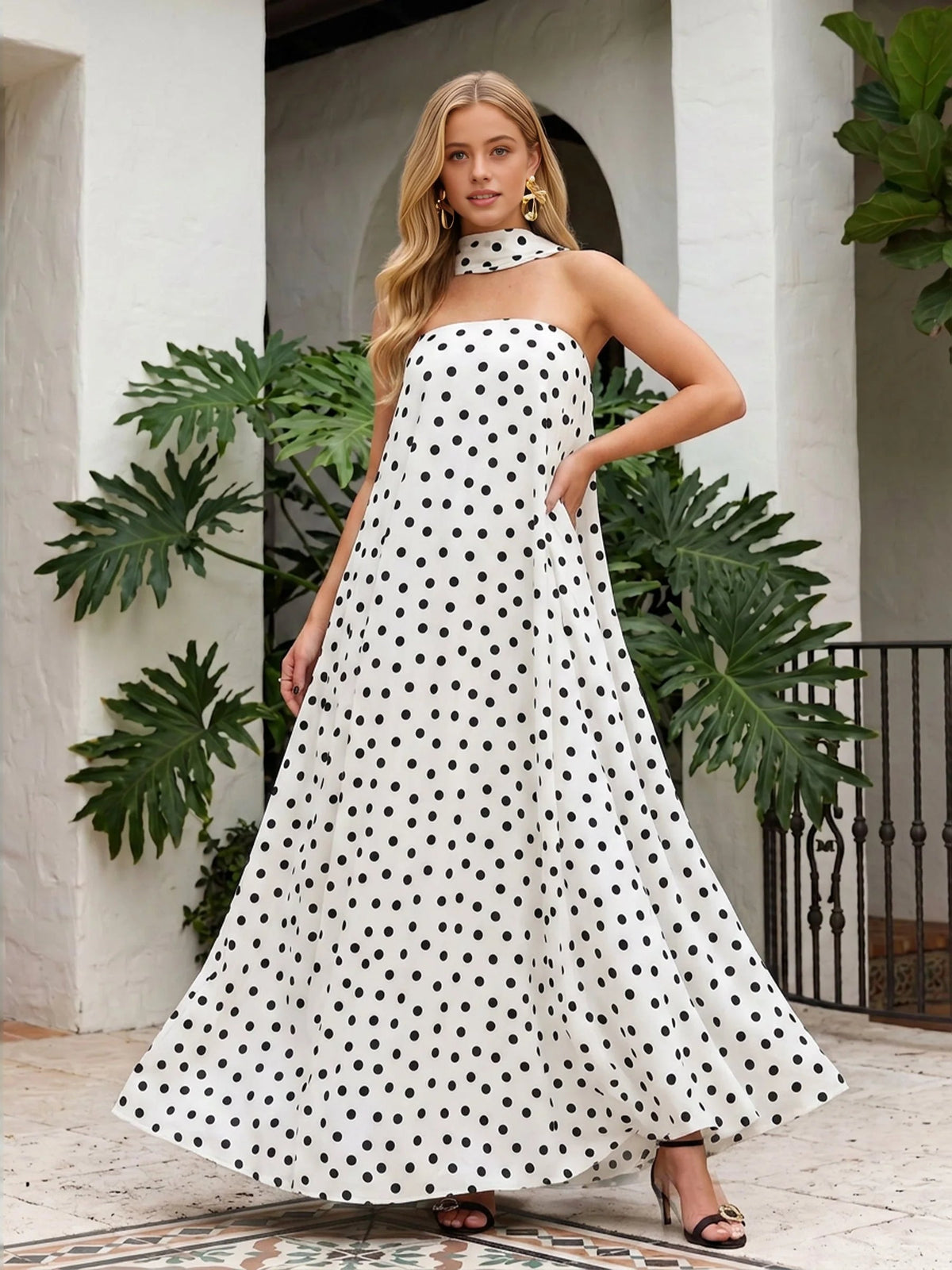 Strapless A-line maxi dress in white with black polka dots, flared skirt
