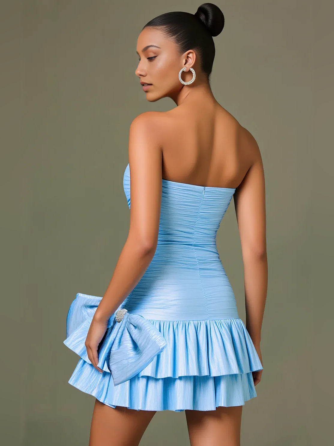 Light blue strapless mini bodycon dress in back view with ruched bodice and tiered ruffles