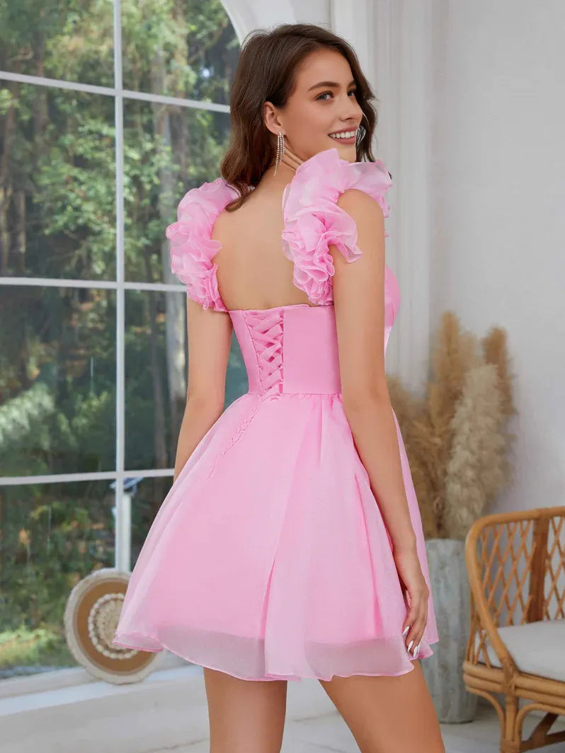 Light pink off-shoulder sweetheart corset mini dress with ruffled shoulder details and A-line tulle skirt