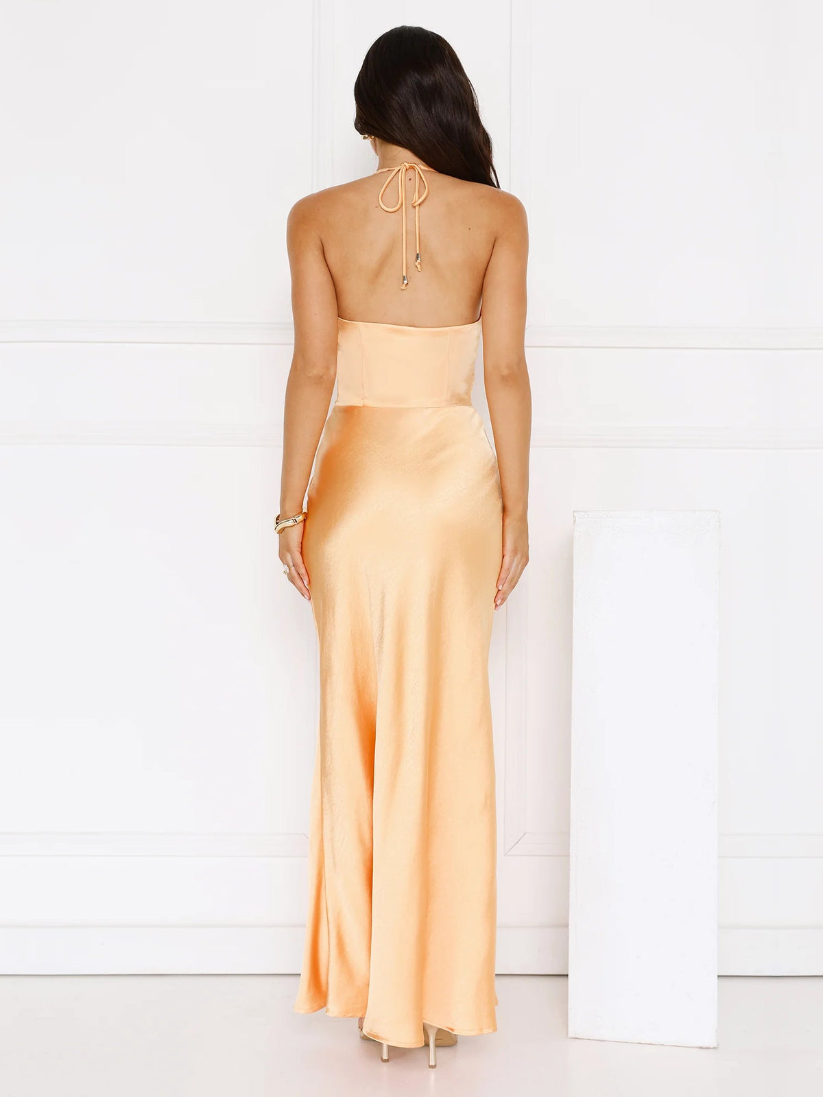 Orange sheath maxi formal dress with skirt slit, full-length back view