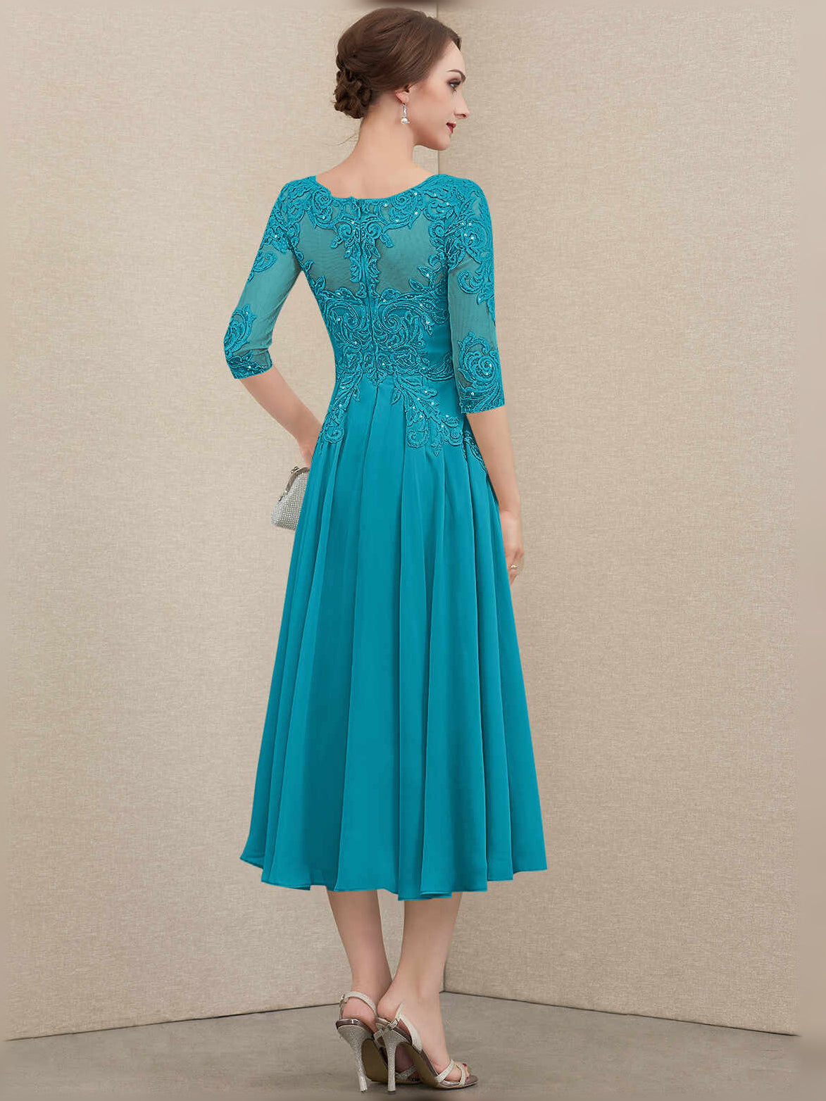 Jade teal pleated chiffon A-line dress with embroidered illusion neckline, 3/4 back view