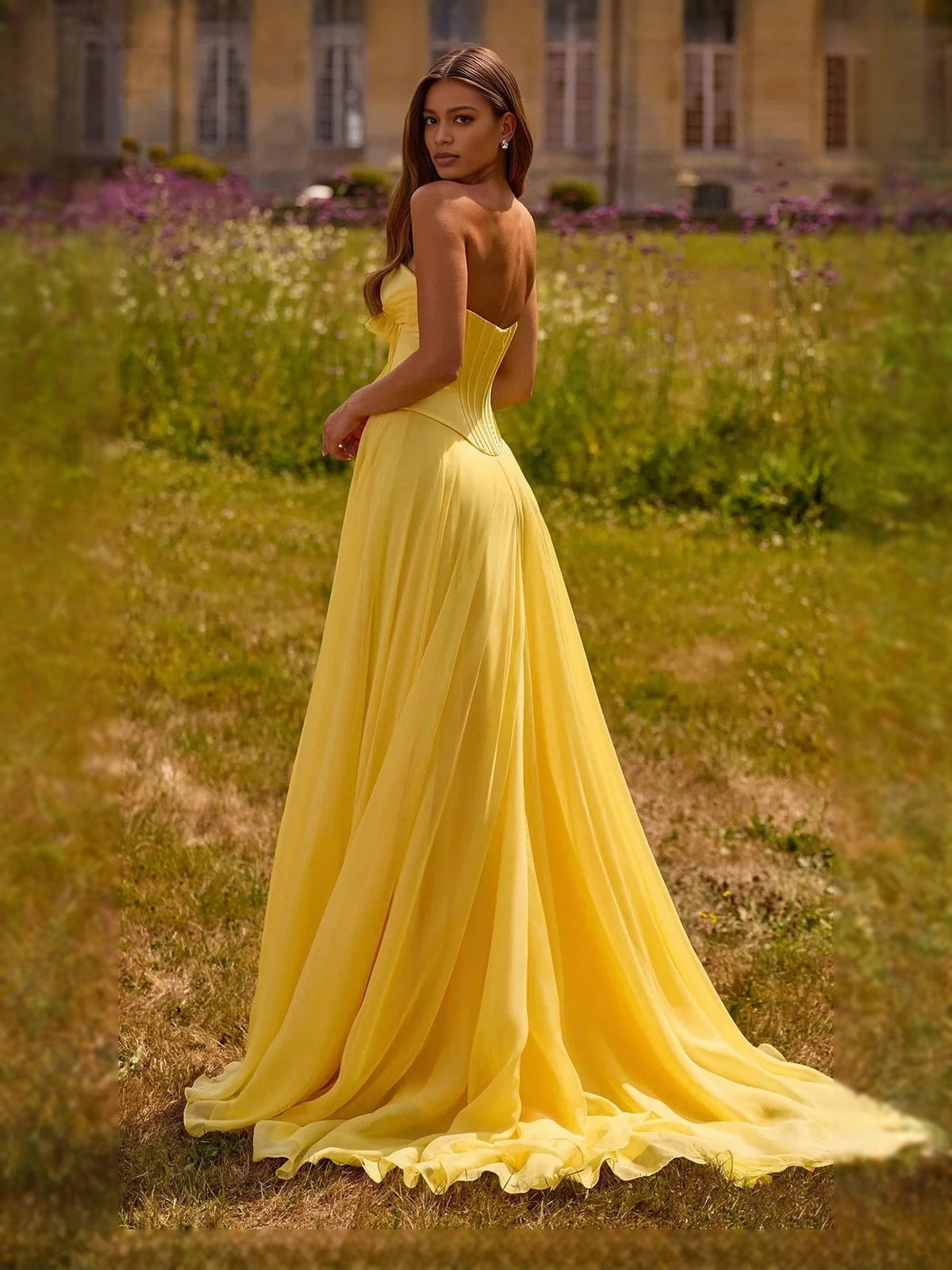Yellow sweetheart A-line prom dress with corset bodice bow and flowing skirt