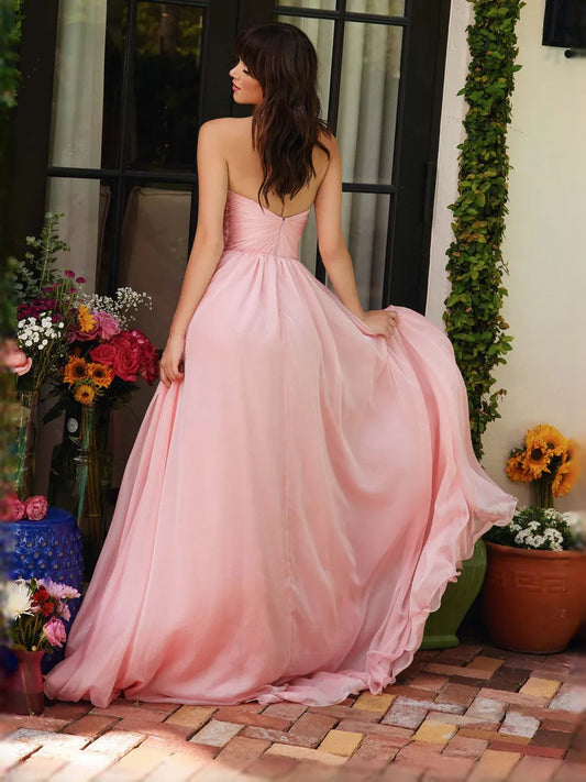 Light pink formal gown with ruched back bodice and gathered full skirt, floor-length