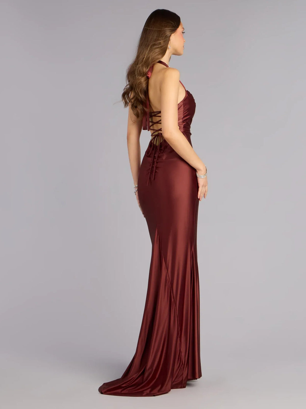 Burgundy halter neck corset formal dress with open back and floor-length fitted skirt