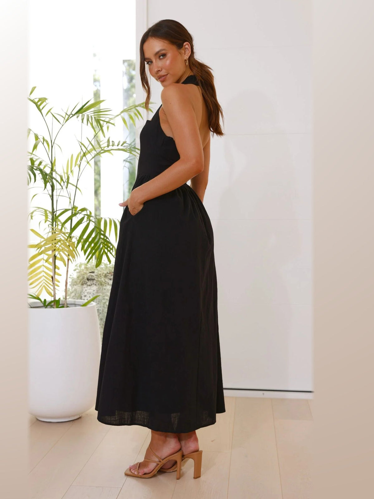 Black midi formal dress, back full-length view showing the bodice