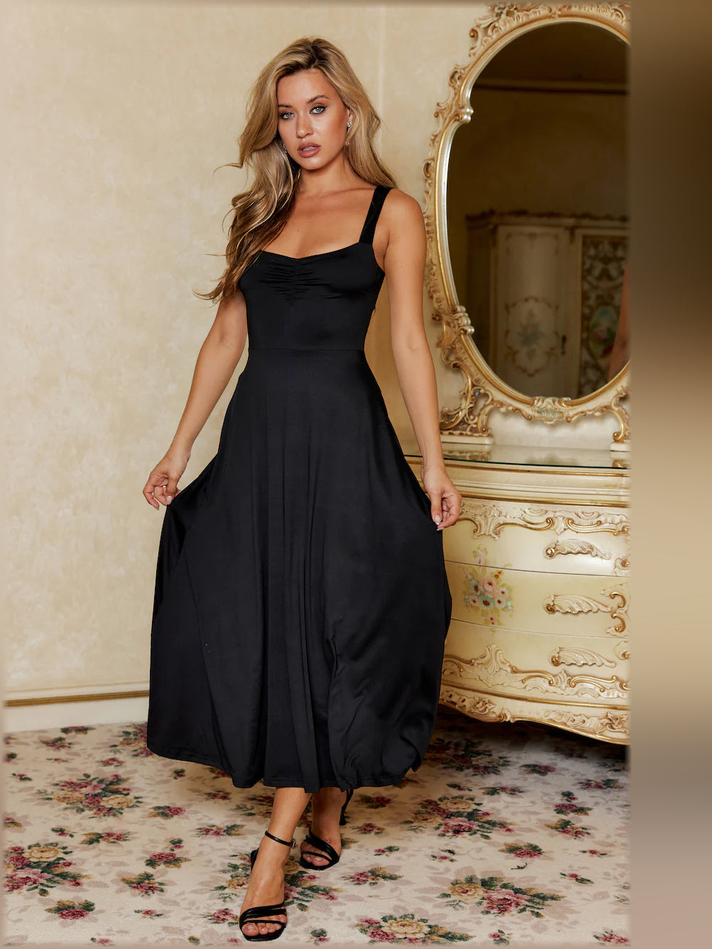Black midi formal dress with spaghetti straps and gathered fitted bodice, flowing skirt