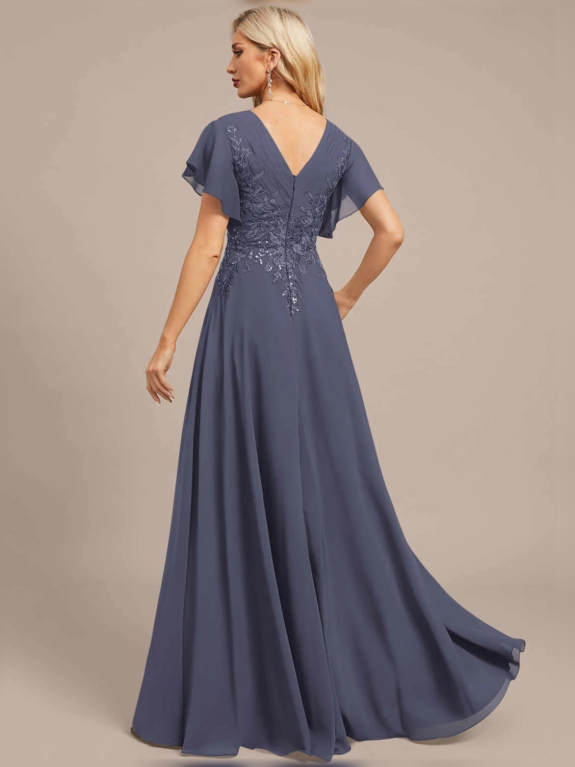 Blue V-neck A-line maxi dress, side view, with floral embroidery on pleated chiffon.