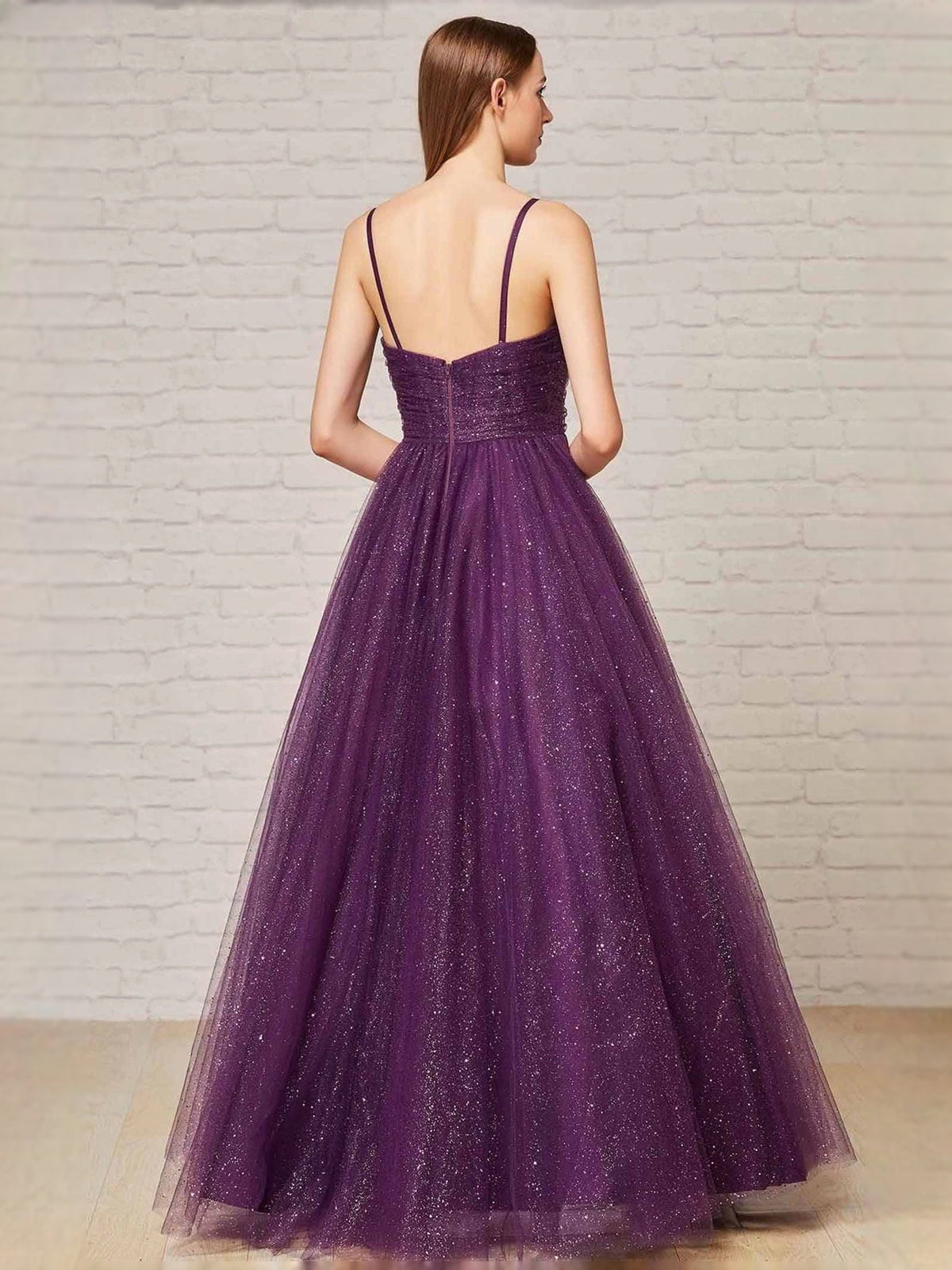 Deep purple glitter prom dress back view with thin straps and A-line tulle skirt