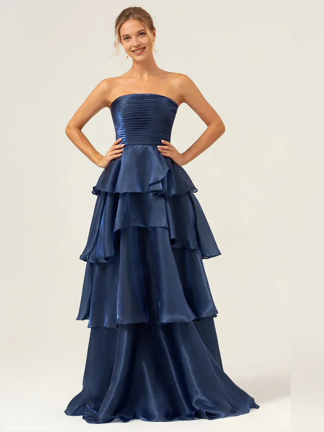 Dark blue strapless prom dress with ruched bodice and layered tiered ruffle skirt, floor length