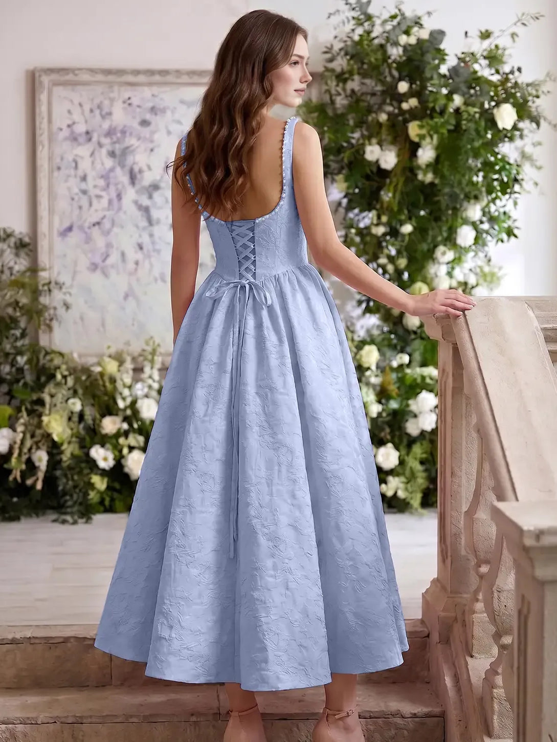Light blue corset tea-length dress, back view, sleeveless with gathered full skirt