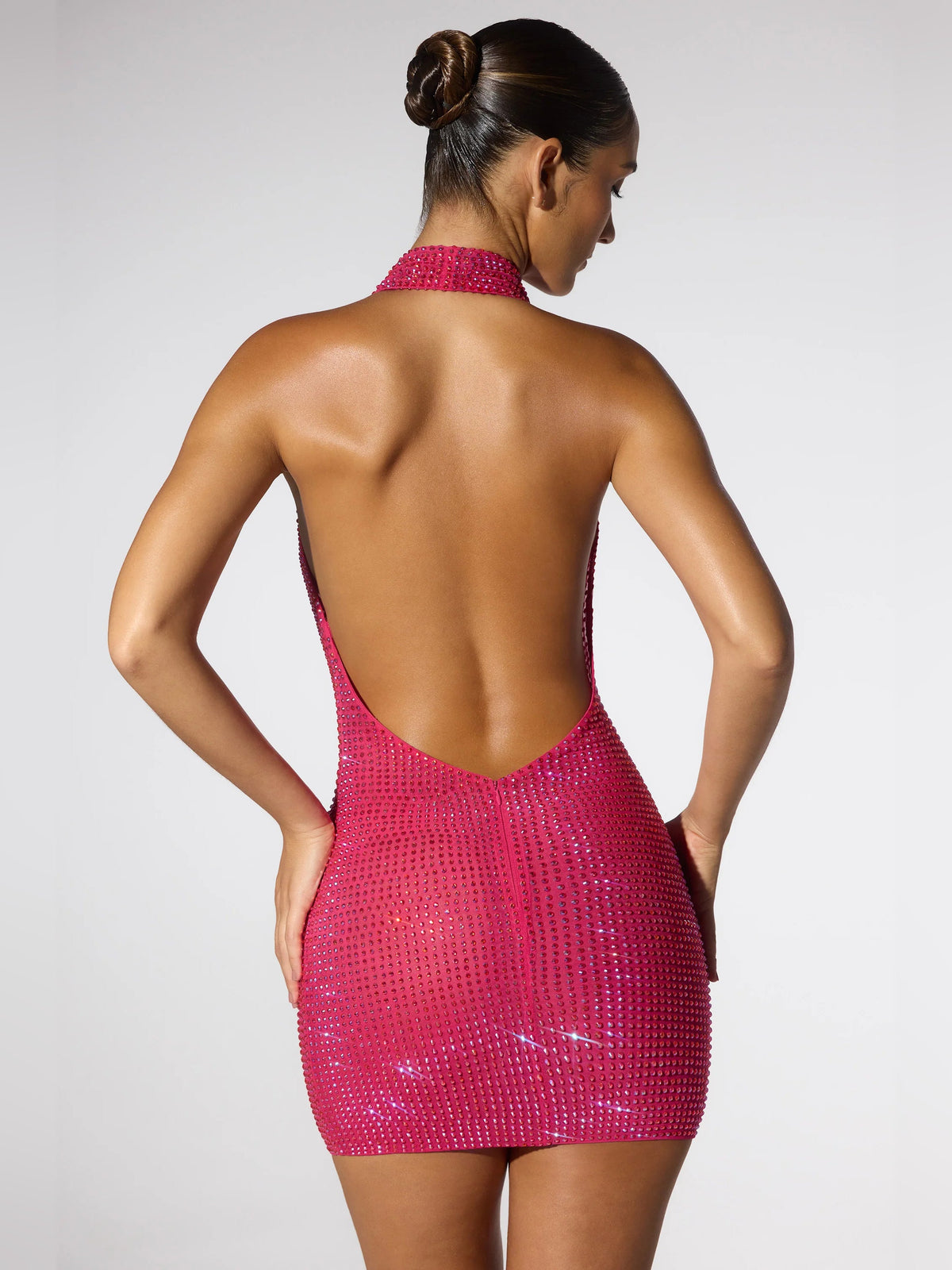 Hot pink sequin mini dress with open back and halter cowl neckline