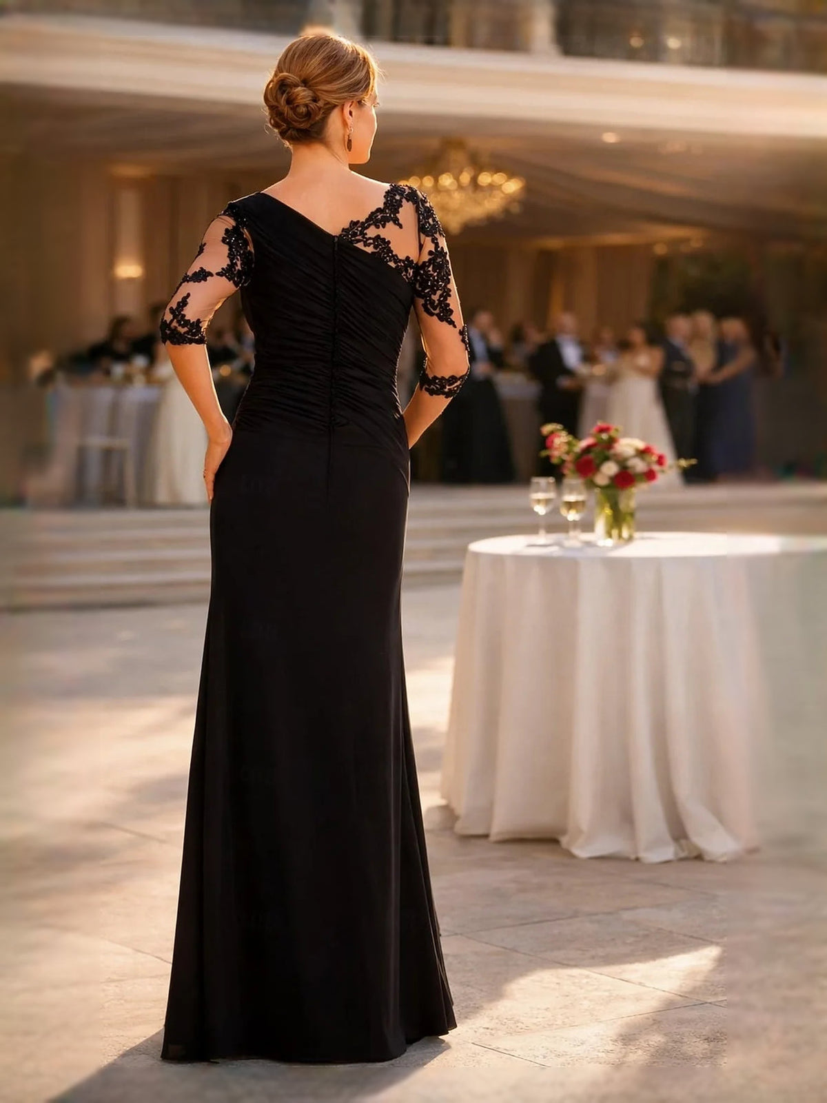 Black one-shoulder sheath dress with lace sleeves, ruched back detail, floor length
