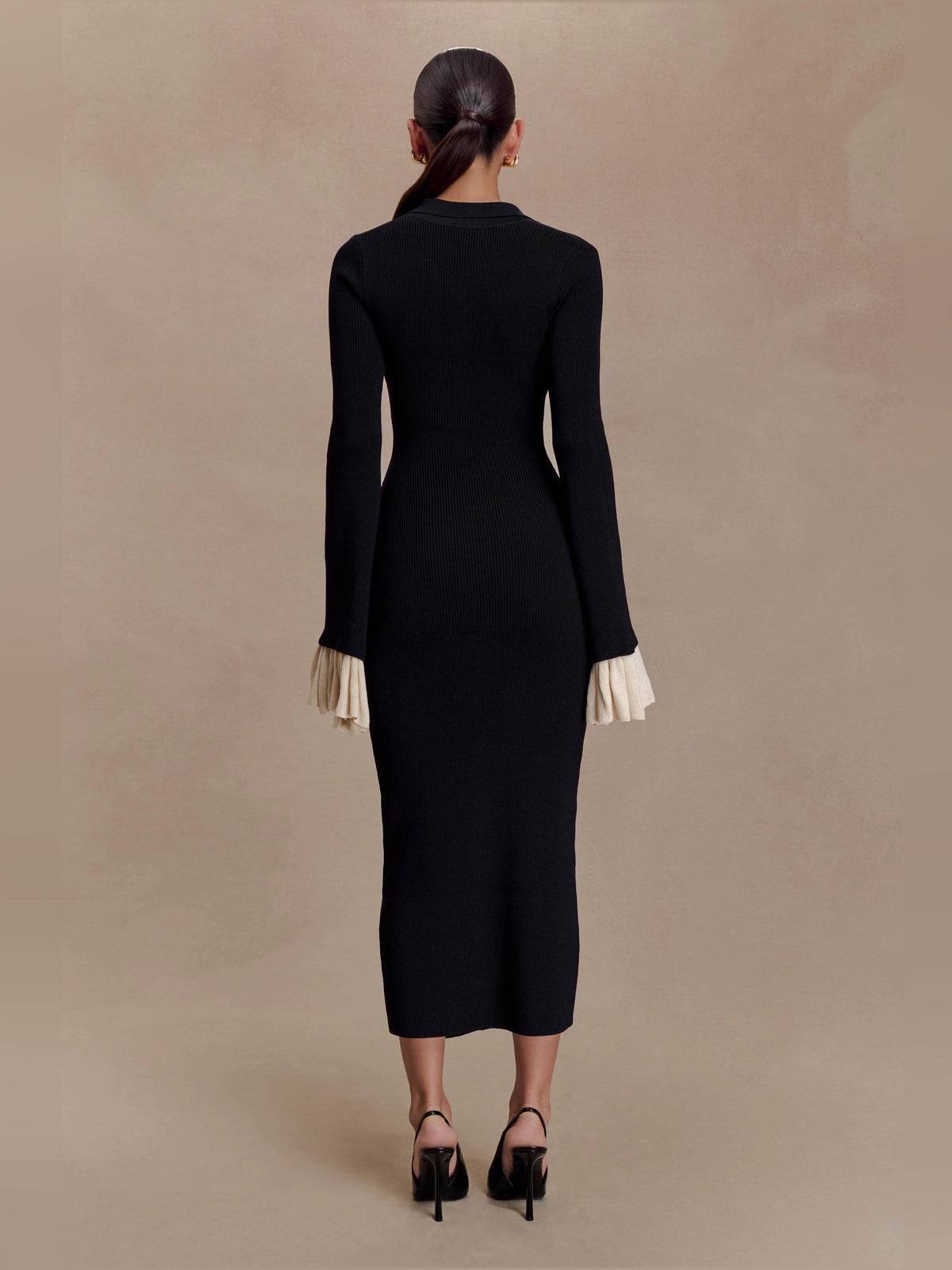 Amirose black knit midi dress back view, long sleeves, cream ruffle cuffs