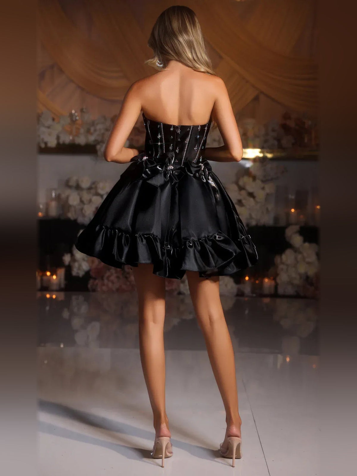 Black strapless satin mini dress with corset back and ruffled flared hem