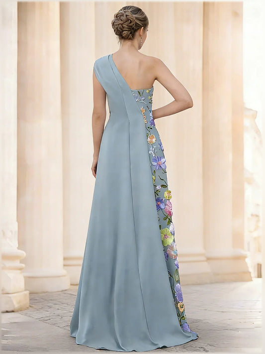 Dusty blue one-shoulder formal dress with floral embroidered side panel, open back, floor-length