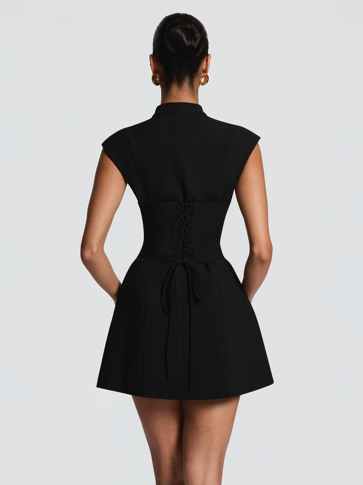 Black back view of sleeveless fit-and-flare mini dress with ribbon tie waist