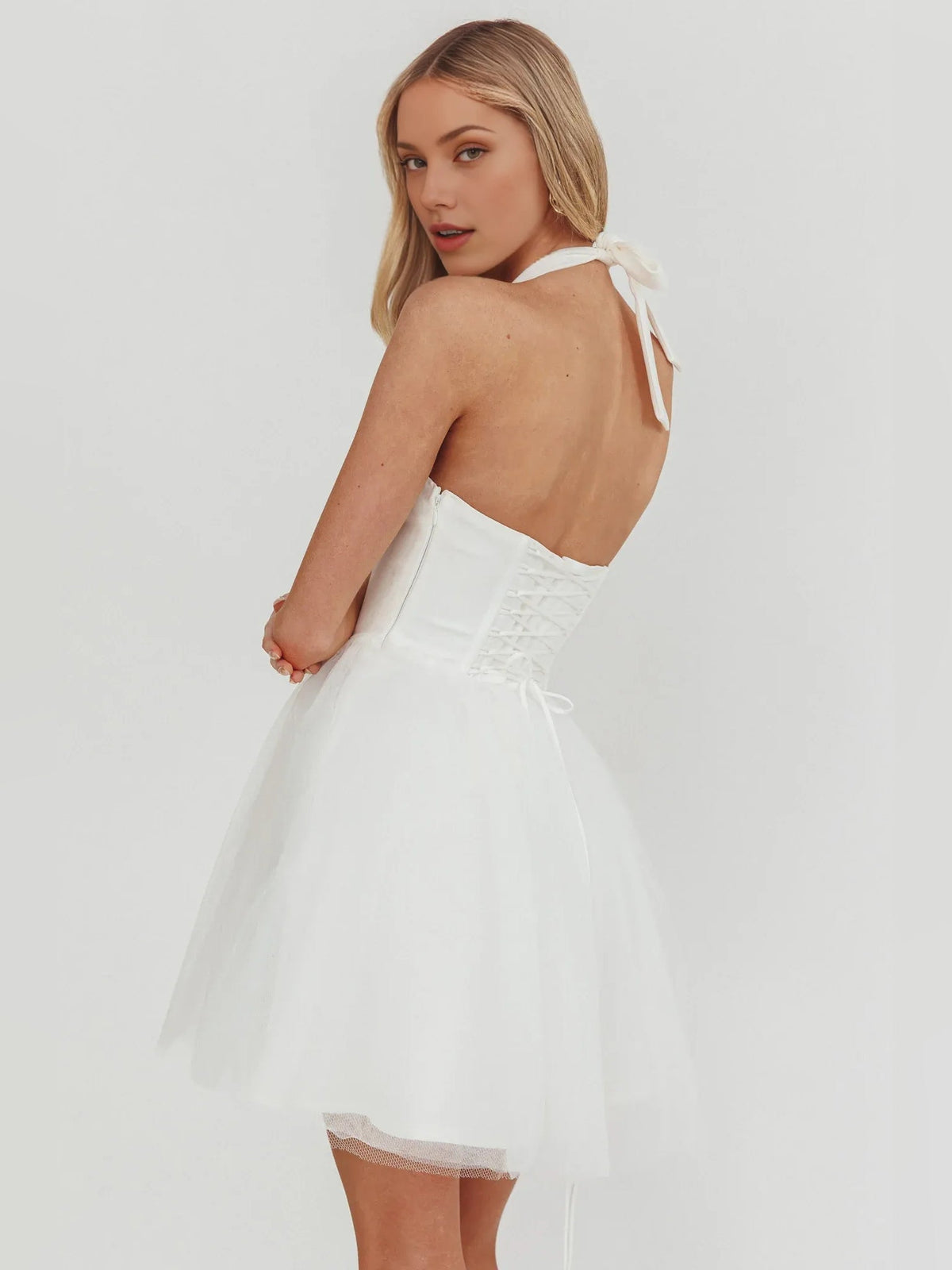 White halter corset mini dress, open back with bow detail
