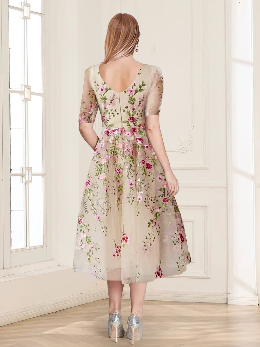 Back view of champagne tulle A-line tea-length dress with floral embroidery