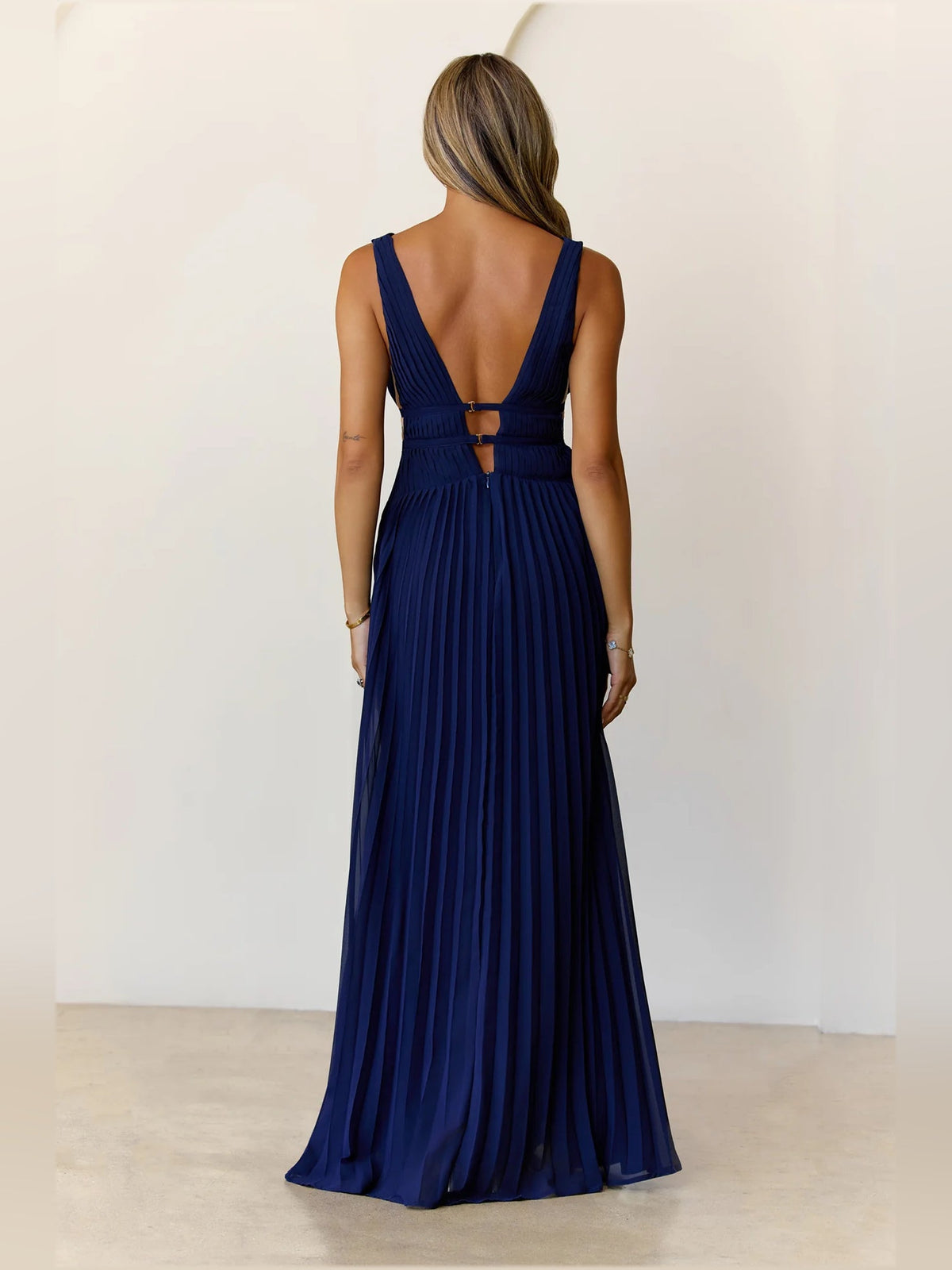 Navy a-line maxi formal dress with pleated skirt, full-length back view