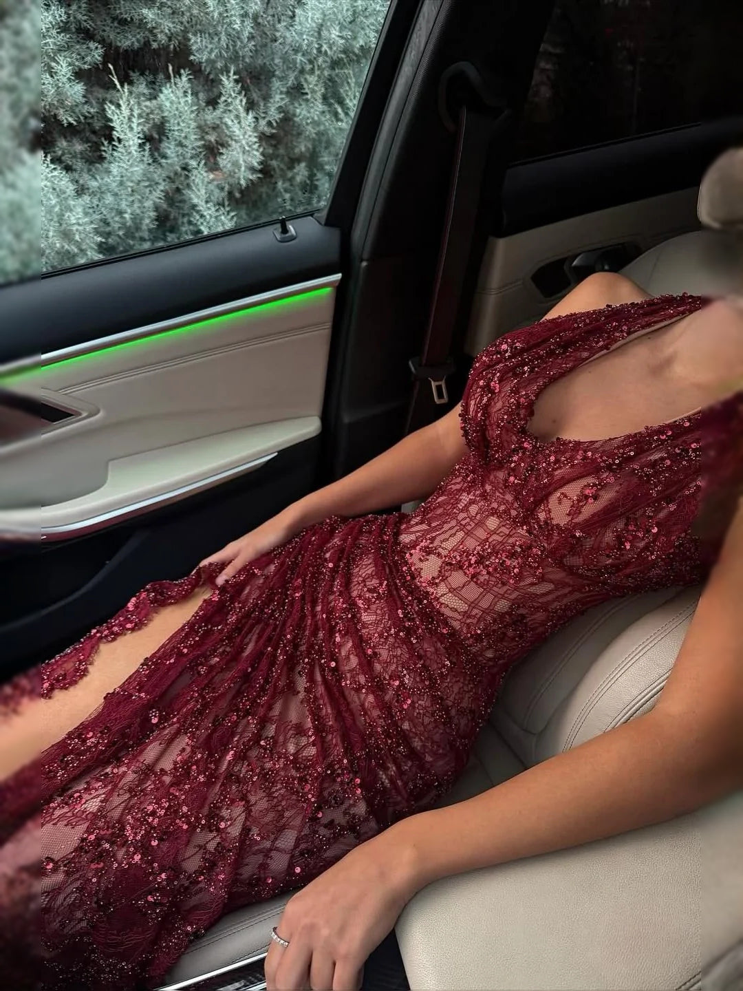 Deep red sequin mermaid prom dress with deep V neckline and side slit, sheer lace panels