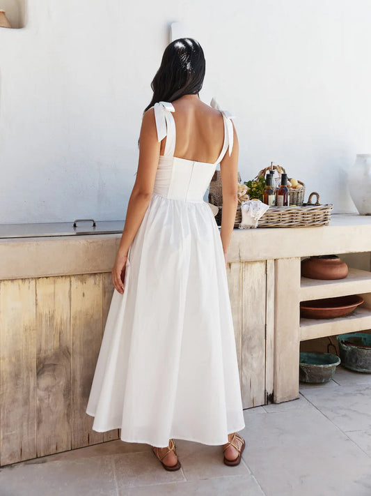 White midi formal dress, open back with bow straps, fitted bodice and full skirt.