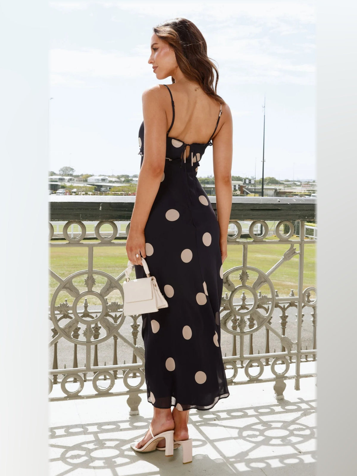 Black maxi formal dress, back full-length view showing the bodice