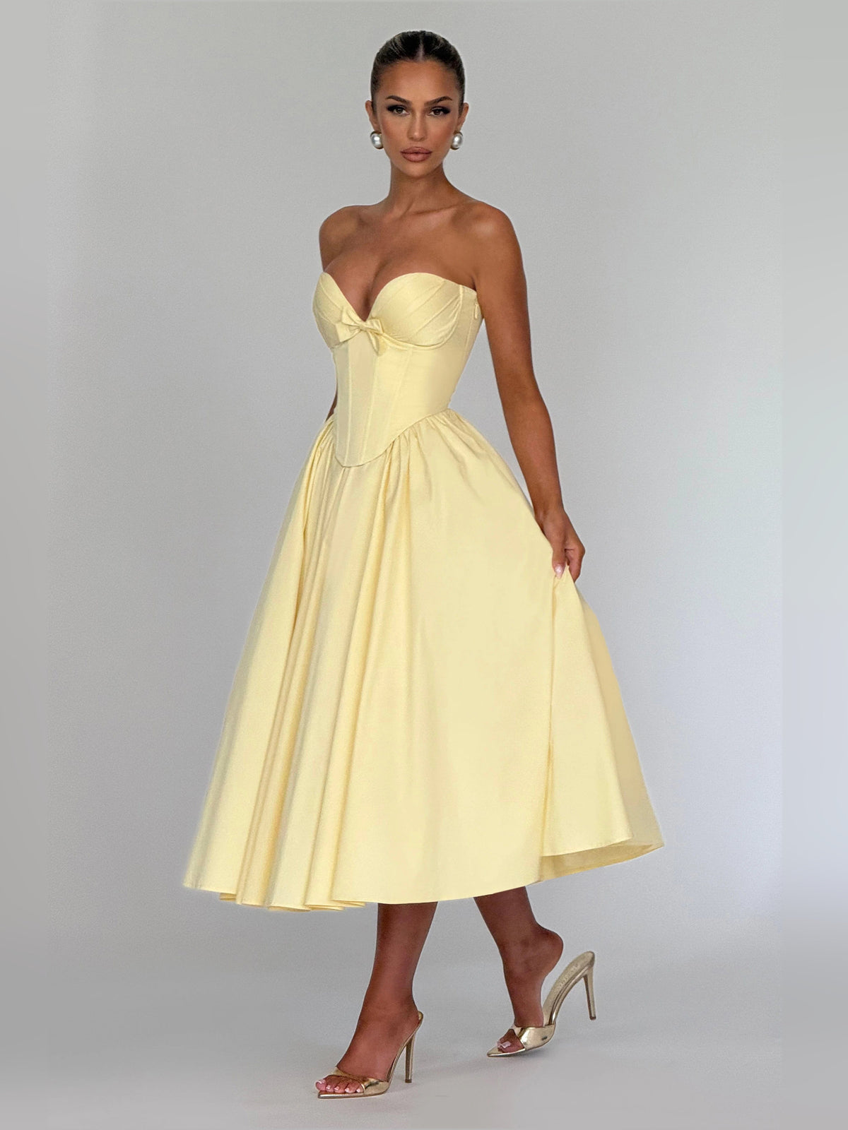 Lemon yellow strapless midi formal dress with fitted bodice, bow detail, and flared skirt