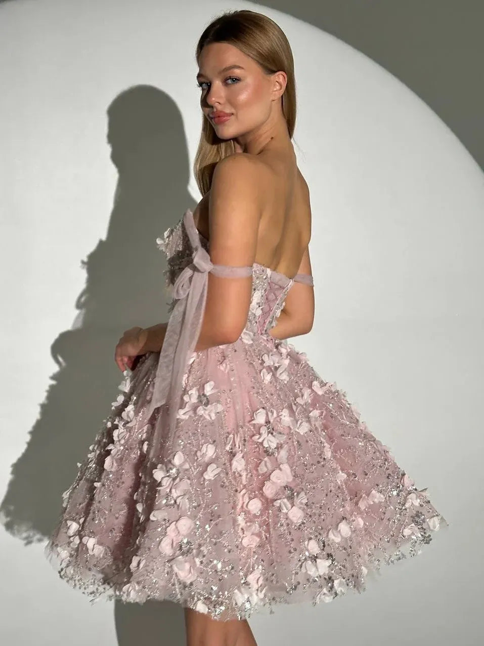 Blush pink off-shoulder corset mini dress with floral applique, tulle skirt, ribbon back bow