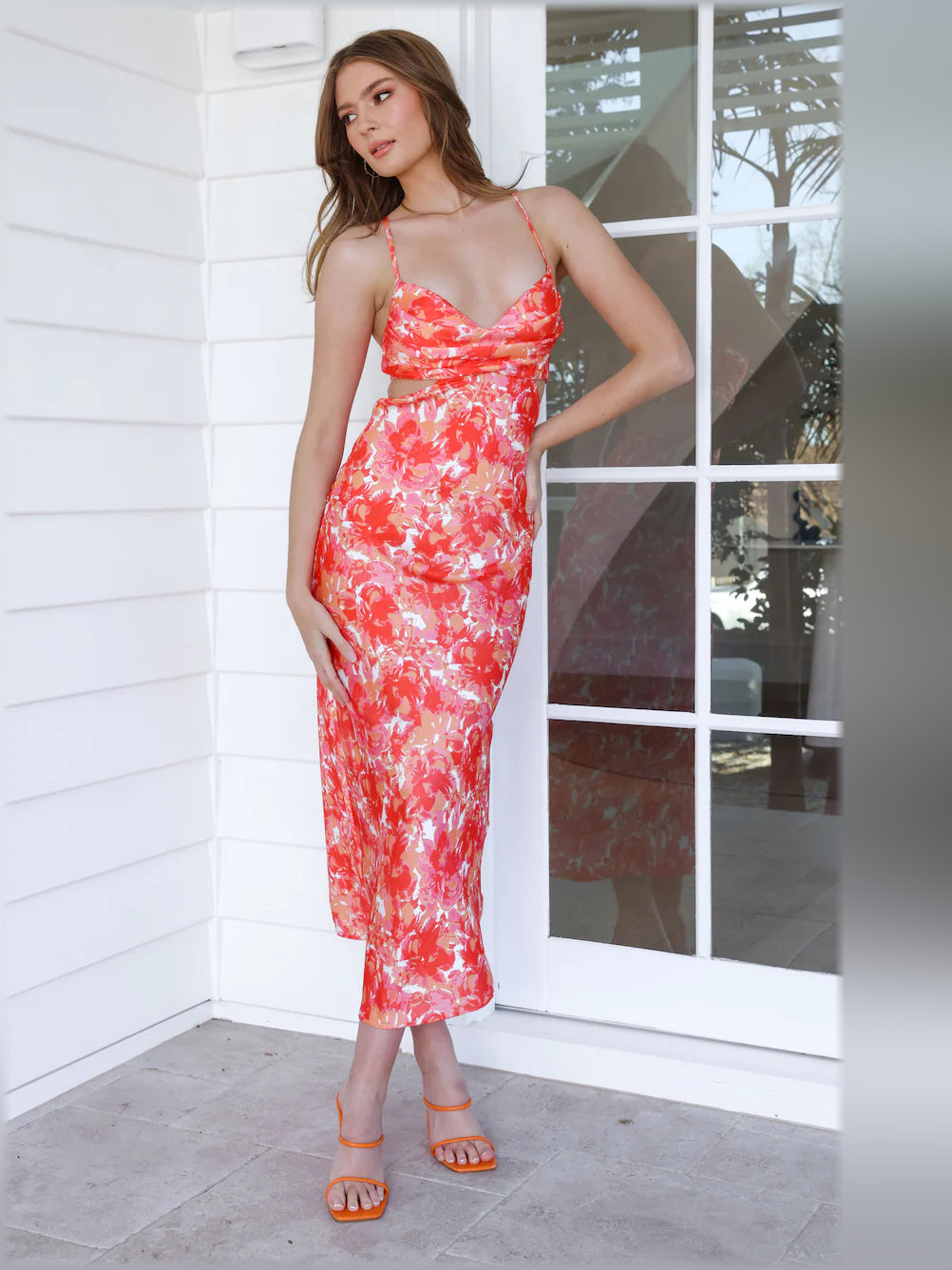 Orange and red floral midi formal dress with V-neckline, spaghetti straps, and bodycon fit