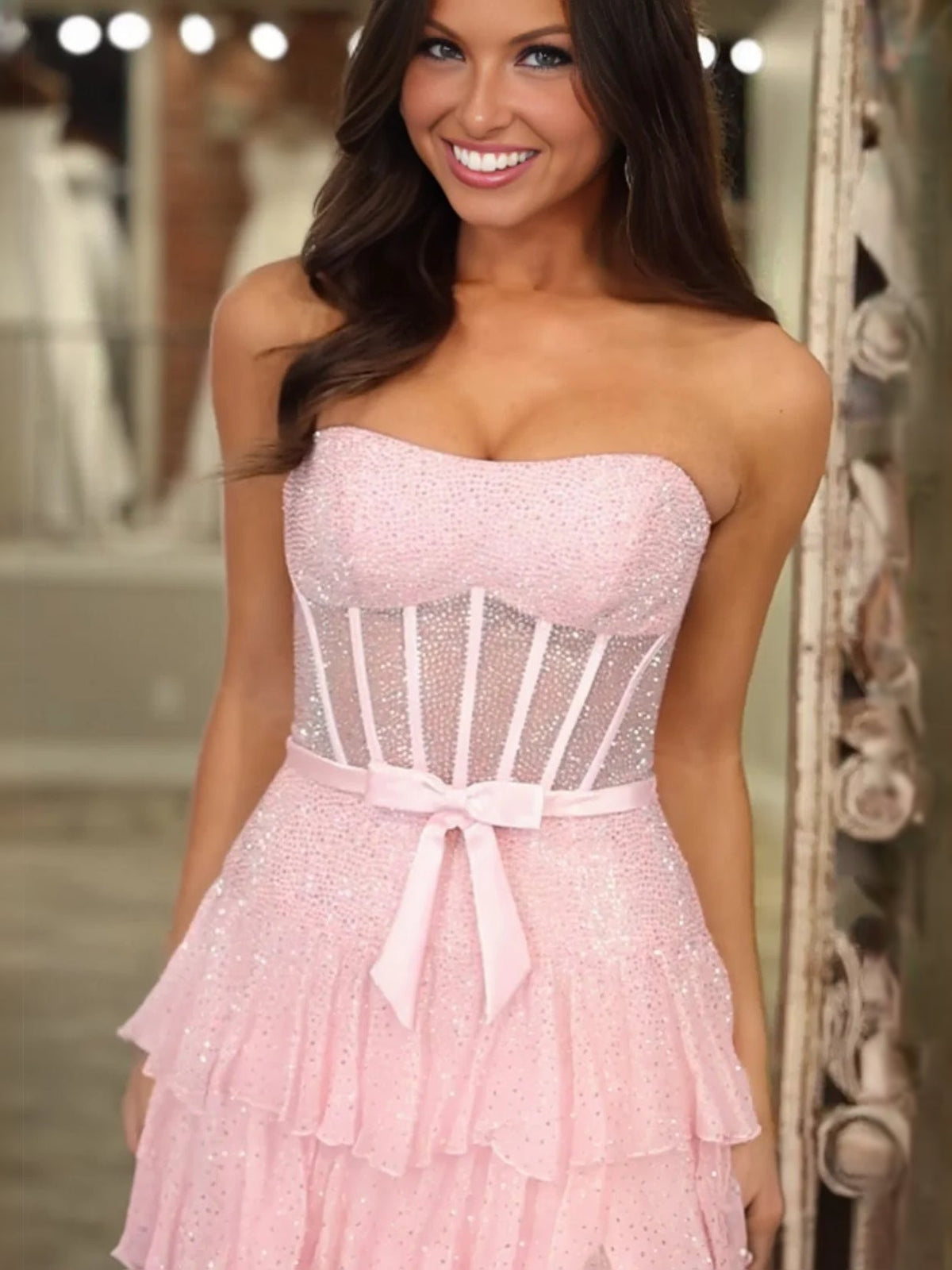 Pink glitter strapless bodice with corset lacing, bow belt, and tiered tulle skirt