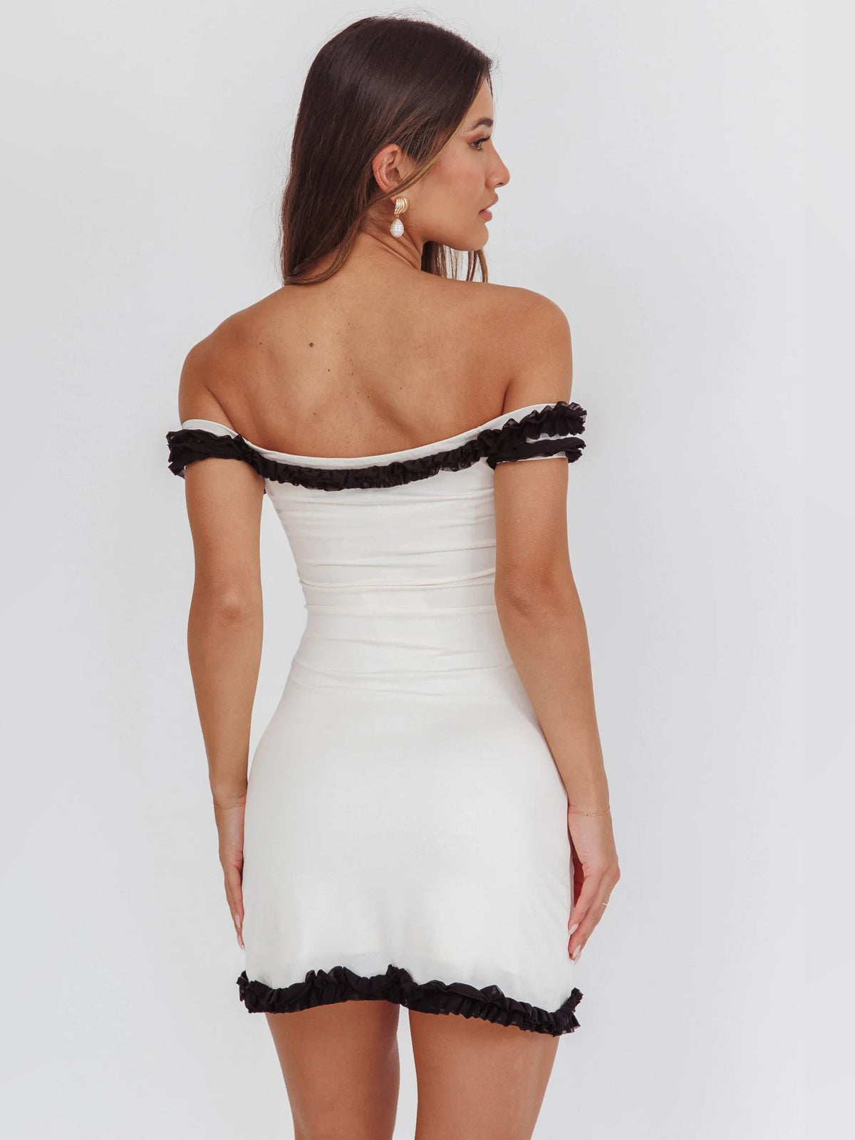 Cream off-shoulder mini dress with black trim edging, open back shown