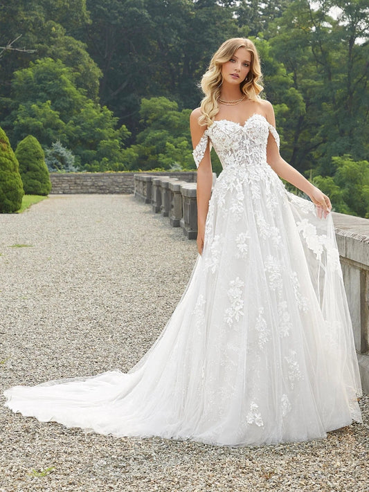 Ivory A-line tulle wedding dress with sweetheart neckline, floral embroidery, veil-like skirt